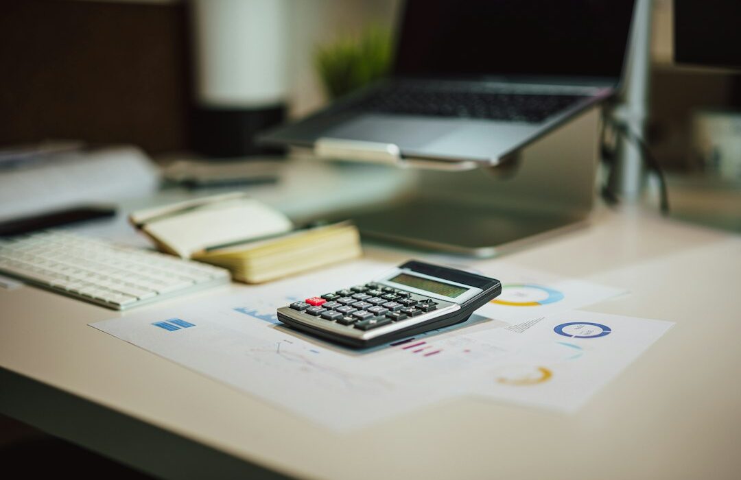 Calculator and financial paperwork on a desk